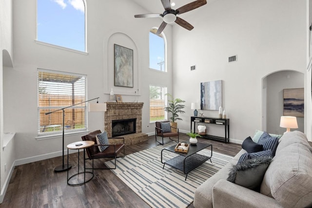 122 Retama Dr, Georgetown, TX 78626 - living room featuring a high ceiling, a ceiling fan, arched walkways, and baseboards