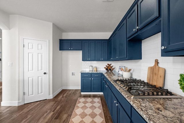 122 Retama Dr, Georgetown, TX 78626 - kitchen featuring blue cabinets, stainless steel gas stovetop, dark wood-style flooring, baseboards, and light stone countertops