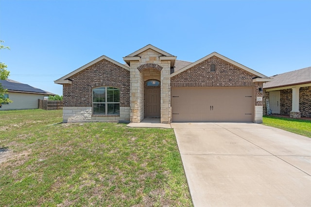 609 Ibis Falls Loop, Jarrell, TX 76537 - view of front of property with brick siding, an attached garage, and concrete driveway