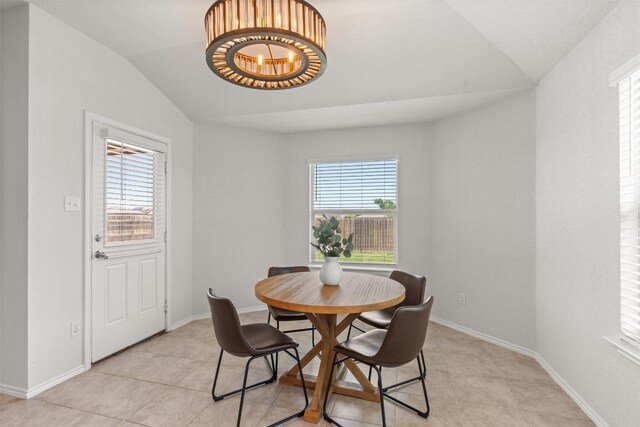 609 Ibis Falls Loop, Jarrell, TX 76537 - dining space with lofted ceiling, plenty of natural light, light tile patterned floors, a chandelier, and baseboards