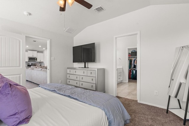 609 Ibis Falls Loop, Jarrell, TX 76537 - bedroom with lofted ceiling, light carpet, a spacious closet, a ceiling fan, and ensuite bath