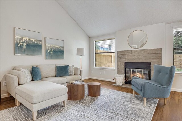 12910 Steeple Chase Dr, Austin, TX 78729 - living area with baseboards, wood finished floors, a fireplace, and high vaulted ceiling