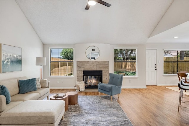 12910 Steeple Chase Dr, Austin, TX 78729 - living room with wood finished floors, a ceiling fan, baseboards, and high vaulted ceiling