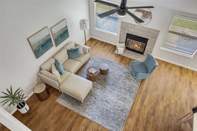 12910 Steeple Chase Dr, Austin, TX 78729 - living room with a ceiling fan, baseboards, a fireplace, wood finished floors, and healthy amount of natural light