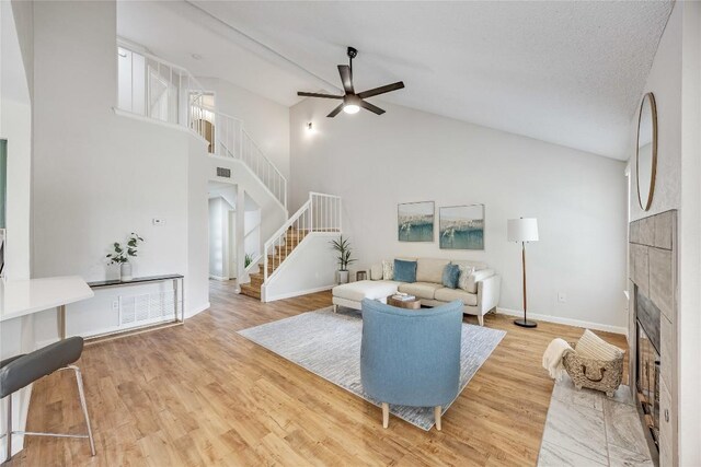 12910 Steeple Chase Dr, Austin, TX 78729 - living area with stairs, ceiling fan, wood finished floors, a fireplace, and baseboards