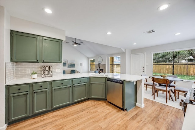 12910 Steeple Chase Dr, Austin, TX 78729 - kitchen with dishwasher, green cabinets, a peninsula, light wood-type flooring, and vaulted ceiling