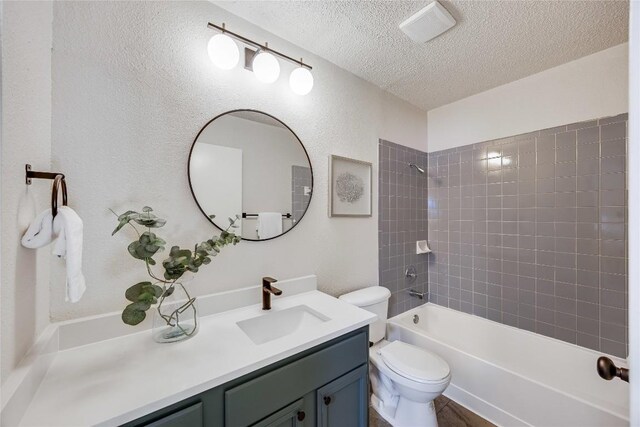 12910 Steeple Chase Dr, Austin, TX 78729 - bathroom featuring a textured ceiling, vanity, toilet, and bathing tub / shower combination