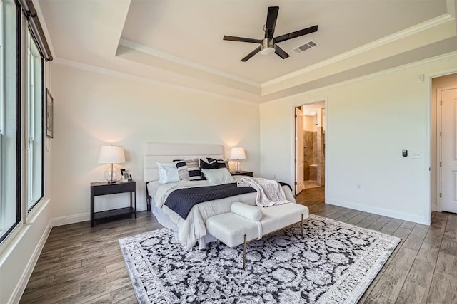 318 Fairway Ridge Rd, Georgetown, TX 78633 - bedroom featuring a tray ceiling, wood finished floors, crown molding, baseboards, and connected bathroom