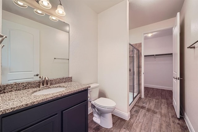 318 Fairway Ridge Rd, Georgetown, TX 78633 - full bathroom with wood finished floors, a stall shower, vanity, toilet, and a spacious closet