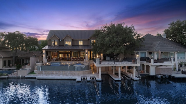101 Matern Ct, Horseshoe Bay, TX 78657 - rear view of house featuring a water view, metal roof, and a patio