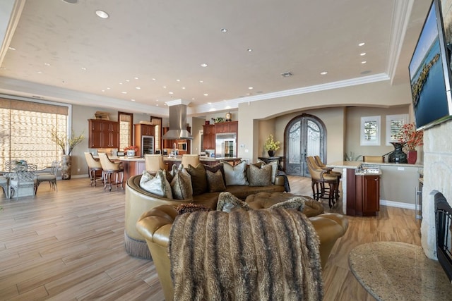 101 Matern Ct, Horseshoe Bay, TX 78657 - living area featuring a fireplace, light wood finished floors, ornamental molding, recessed lighting, and baseboards