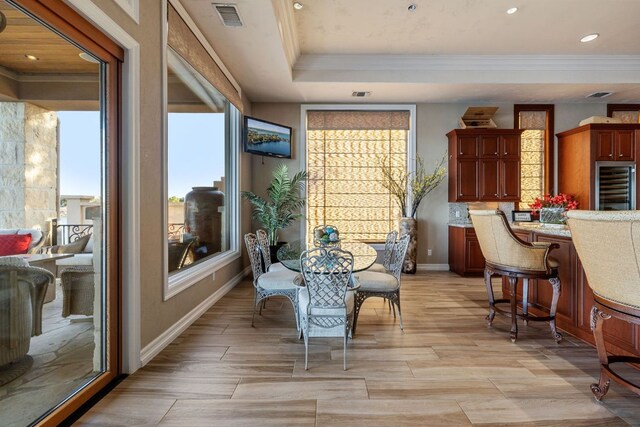 101 Matern Ct, Horseshoe Bay, TX 78657 - dining space with wine cooler, baseboards, ornamental molding, recessed lighting, and light wood-type flooring