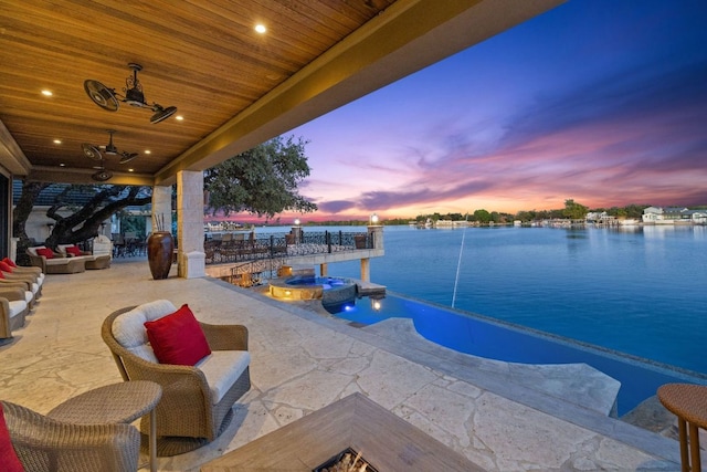 101 Matern Ct, Horseshoe Bay, TX 78657 - view of pool featuring a water view, a pool with connected hot tub, ceiling fan, and a patio area