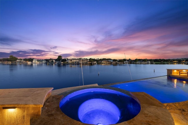 101 Matern Ct, Horseshoe Bay, TX 78657 - pool at dusk with a water view and a pool with connected hot tub