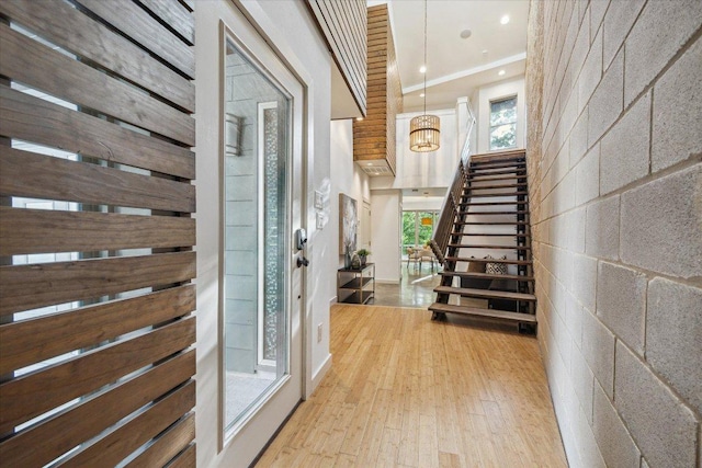 133 Frederick St Unit A, Austin, TX 78704 - foyer entrance with stairway, wood finished floors, healthy amount of natural light, recessed lighting, and a chandelier