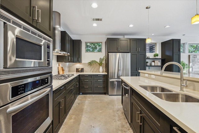 133 Frederick St Unit A, Austin, TX 78704 - kitchen featuring stainless steel appliances, wall chimney exhaust hood, decorative light fixtures, light countertops, and recessed lighting