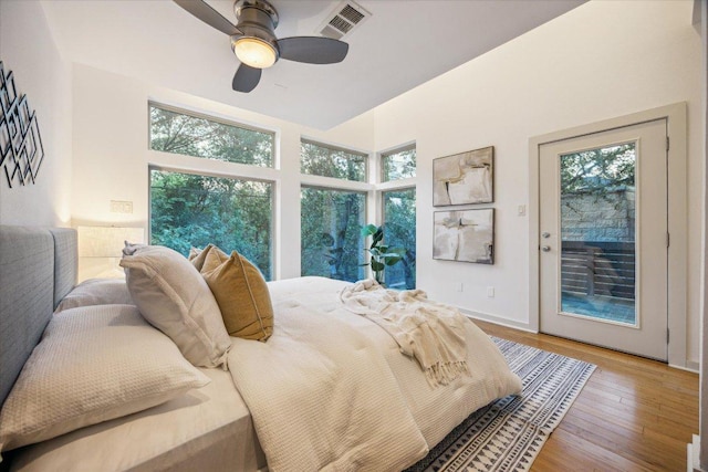 133 Frederick St Unit A, Austin, TX 78704 - bedroom with access to exterior, multiple windows, wood finished floors, and ceiling fan