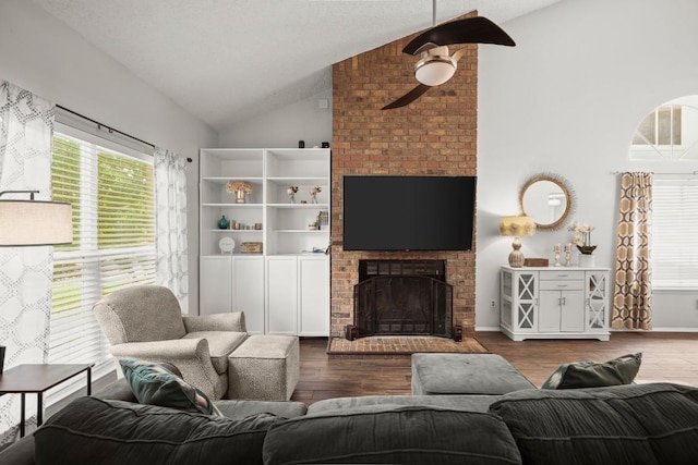 4019 Iriona Bnd, Austin, TX 78749 - living area featuring lofted ceiling, a ceiling fan, a brick fireplace, and dark wood-style floors