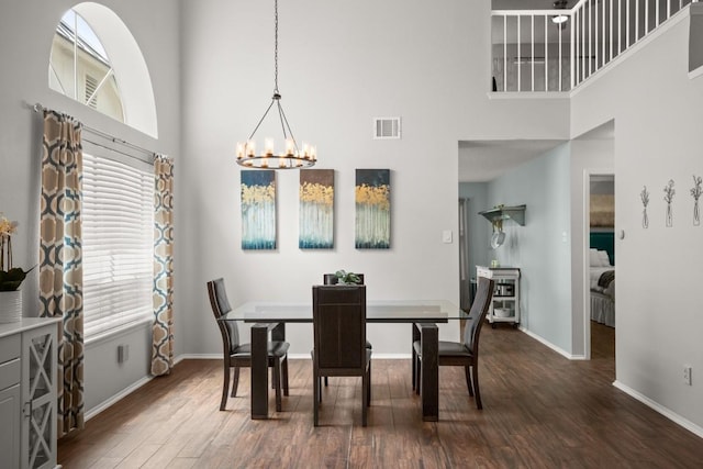 4019 Iriona Bnd, Austin, TX 78749 - dining room with a high ceiling, a chandelier, and dark wood-style floors