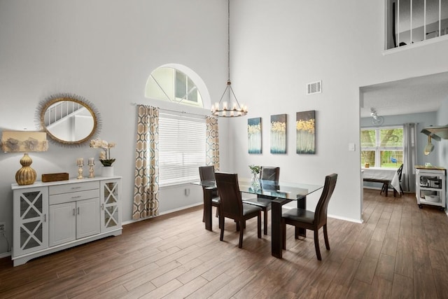 4019 Iriona Bnd, Austin, TX 78749 - dining room with a chandelier, a high ceiling, and dark wood finished floors