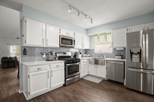 4019 Iriona Bnd, Austin, TX 78749 - kitchen featuring stainless steel appliances, light countertops, white cabinets, backsplash, and a textured ceiling