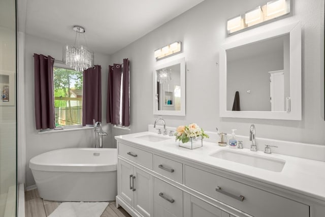 4019 Iriona Bnd, Austin, TX 78749 - full bath featuring double vanity, a freestanding bath, and a chandelier