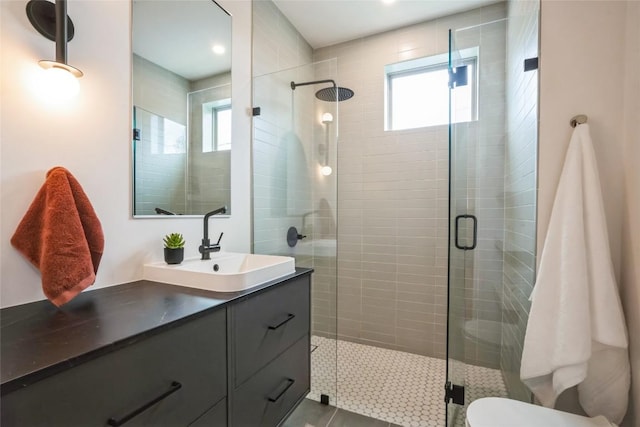 700 Denson Dr Unit 1101, Austin, TX 78752 - full bath featuring vanity, a stall shower, and tile patterned floors