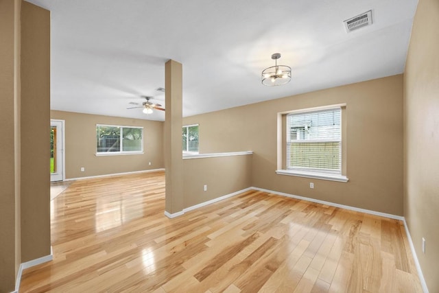 3817 Blue Mountain Path, Round Rock, TX 78681 - spare room with light wood-style flooring, ceiling fan, and a chandelier