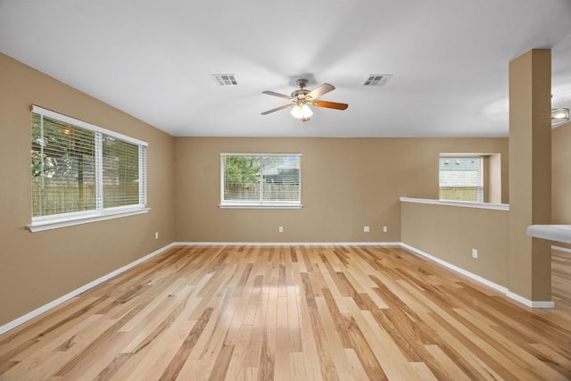 3817 Blue Mountain Path, Round Rock, TX 78681 - empty room with plenty of natural light, light wood finished floors, and a ceiling fan