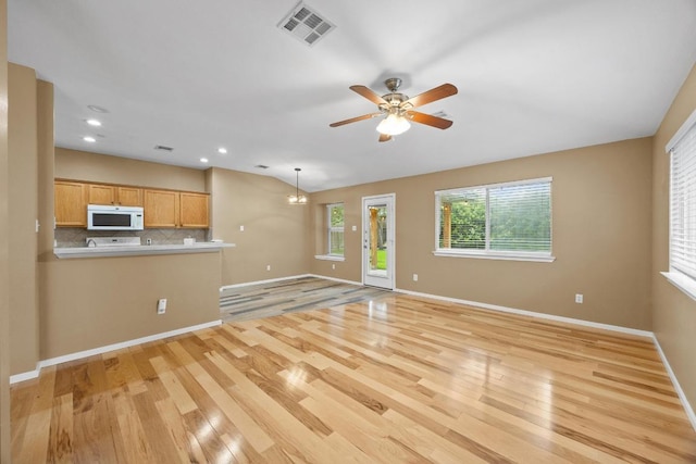 3817 Blue Mountain Path, Round Rock, TX 78681 - unfurnished living room with light wood-style floors, a ceiling fan, recessed lighting, and lofted ceiling