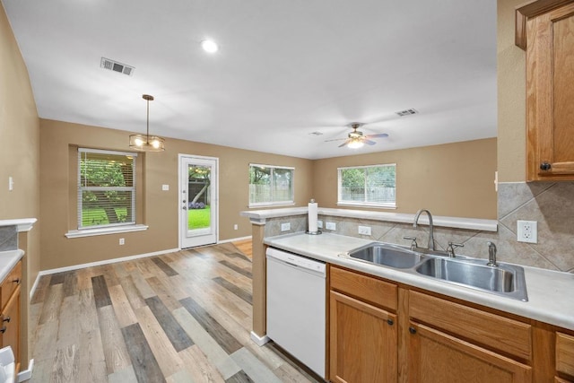 3817 Blue Mountain Path, Round Rock, TX 78681 - kitchen featuring white dishwasher, light wood-style flooring, light countertops, decorative backsplash, and a ceiling fan