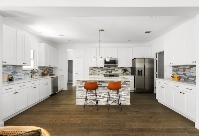 310 Shayla Ln, Canyon Lake, TX 78133 - kitchen with stainless steel appliances, a sink, backsplash, and a breakfast bar