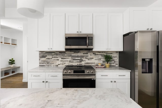 310 Shayla Ln, Canyon Lake, TX 78133 - kitchen featuring stainless steel appliances, light stone counters, and white cabinets