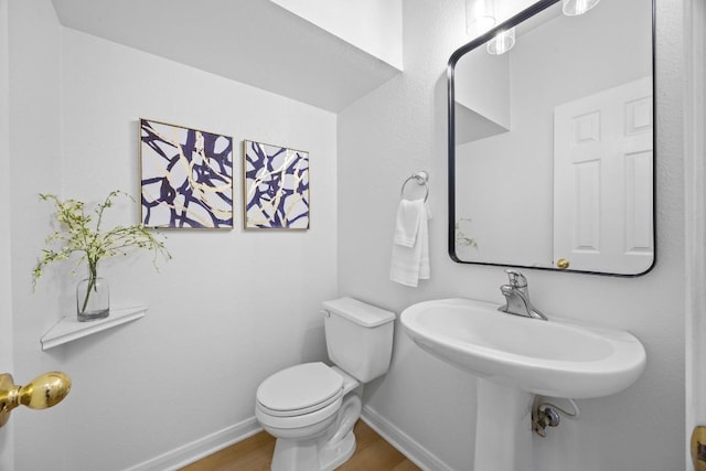 20420 Kearney Hill Rd, Pflugerville, TX 78660 - bathroom with baseboards, wood finished floors, and toilet