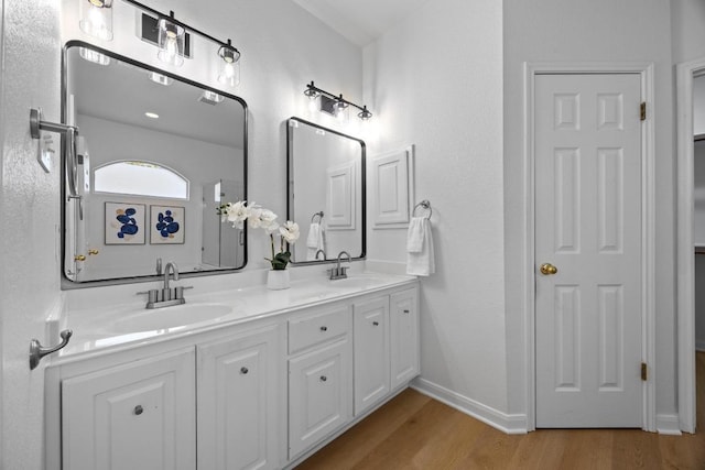 20420 Kearney Hill Rd, Pflugerville, TX 78660 - full bath with double vanity, wood finished floors, and baseboards