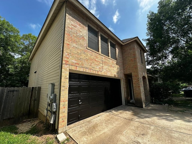 8429 Steamline Cir, Austin, TX 78745 - view of property exterior with an attached garage, brick siding, and driveway