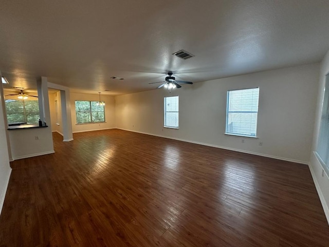 8429 Steamline Cir, Austin, TX 78745 - empty room featuring a ceiling fan, a chandelier, and dark wood-type flooring