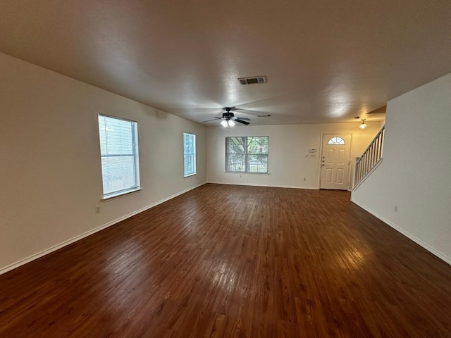 8429 Steamline Cir, Austin, TX 78745 - unfurnished living room featuring dark wood-type flooring, stairs, baseboards, and ceiling fan