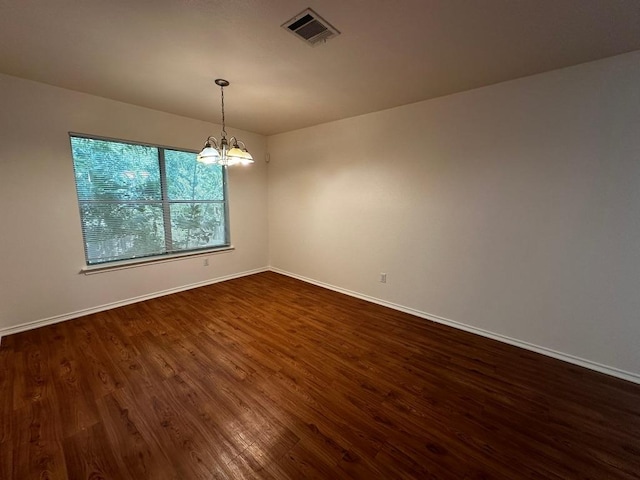8429 Steamline Cir, Austin, TX 78745 - spare room featuring dark wood finished floors, a chandelier, and baseboards