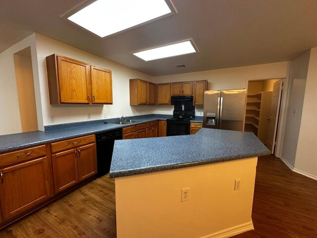 8429 Steamline Cir, Austin, TX 78745 - kitchen featuring black appliances, dark wood finished floors, dark countertops, and brown cabinets