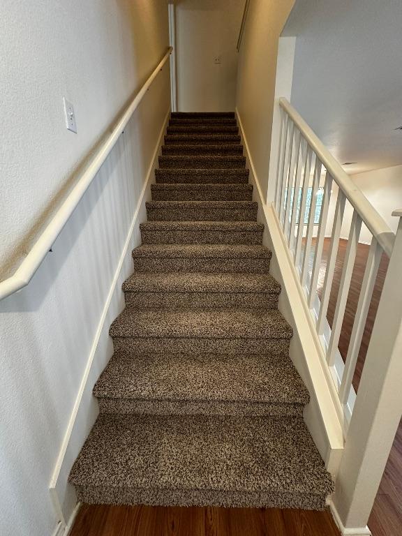 8429 Steamline Cir, Austin, TX 78745 - stairway featuring wood finished floors