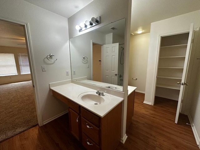 8429 Steamline Cir, Austin, TX 78745 - bathroom featuring wood finished floors, vanity, and baseboards