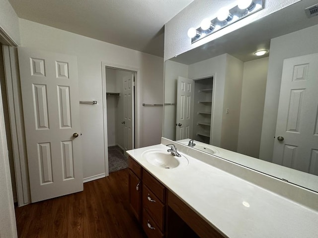 8429 Steamline Cir, Austin, TX 78745 - bathroom featuring wood finished floors, vanity, and baseboards