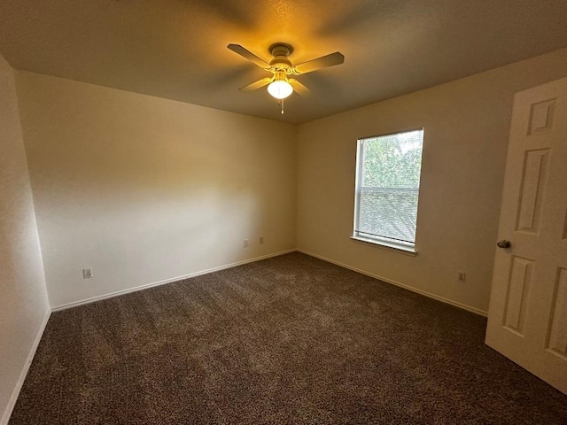 8429 Steamline Cir, Austin, TX 78745 - empty room featuring dark colored carpet, a ceiling fan, and baseboards
