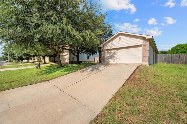 626 Goldenrod St, Kyle, TX 78640 - view of front facade with a garage, brick siding, and concrete driveway