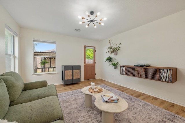 626 Goldenrod St, Kyle, TX 78640 - living room with a chandelier, wood finished floors, and baseboards
