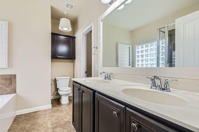 8521 White Ibis Dr, Austin, TX 78729 - bathroom with a garden tub, double vanity, and tile patterned floors