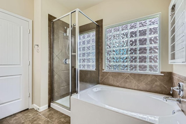 8521 White Ibis Dr, Austin, TX 78729 - full bathroom with a garden tub, a shower stall, and tile patterned flooring