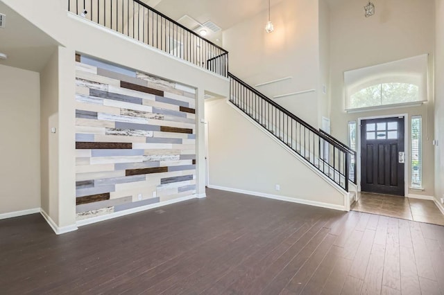 8521 White Ibis Dr, Austin, TX 78729 - foyer entrance featuring a high ceiling, hardwood / wood-style flooring, and stairway