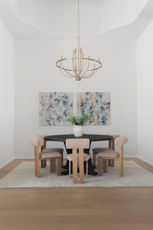 717 Sugar Cane Rd, Buda, TX 78610 - dining space featuring a chandelier, baseboards, and wood finished floors